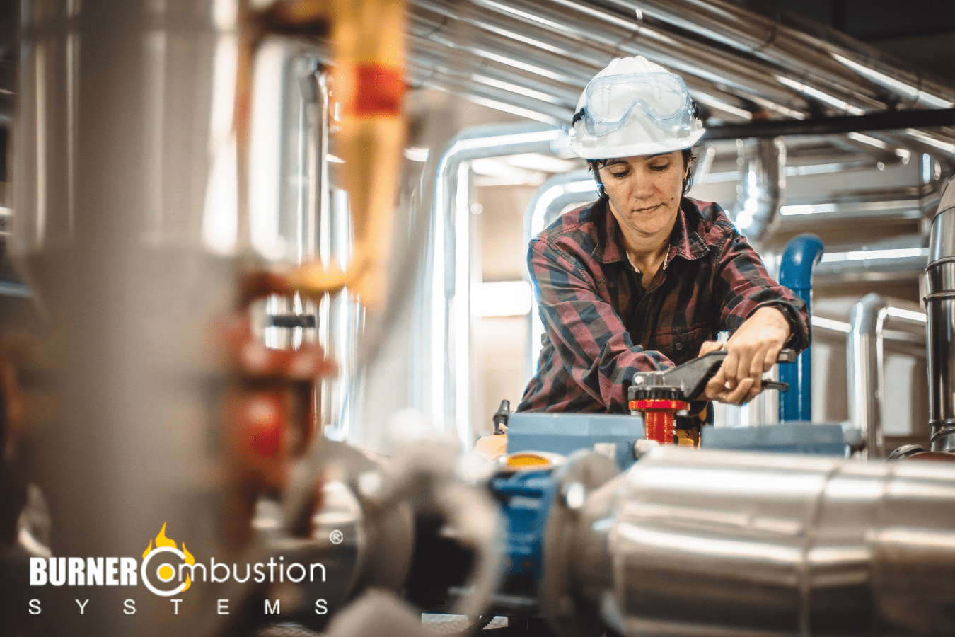 woman with hard hat working on boiler system