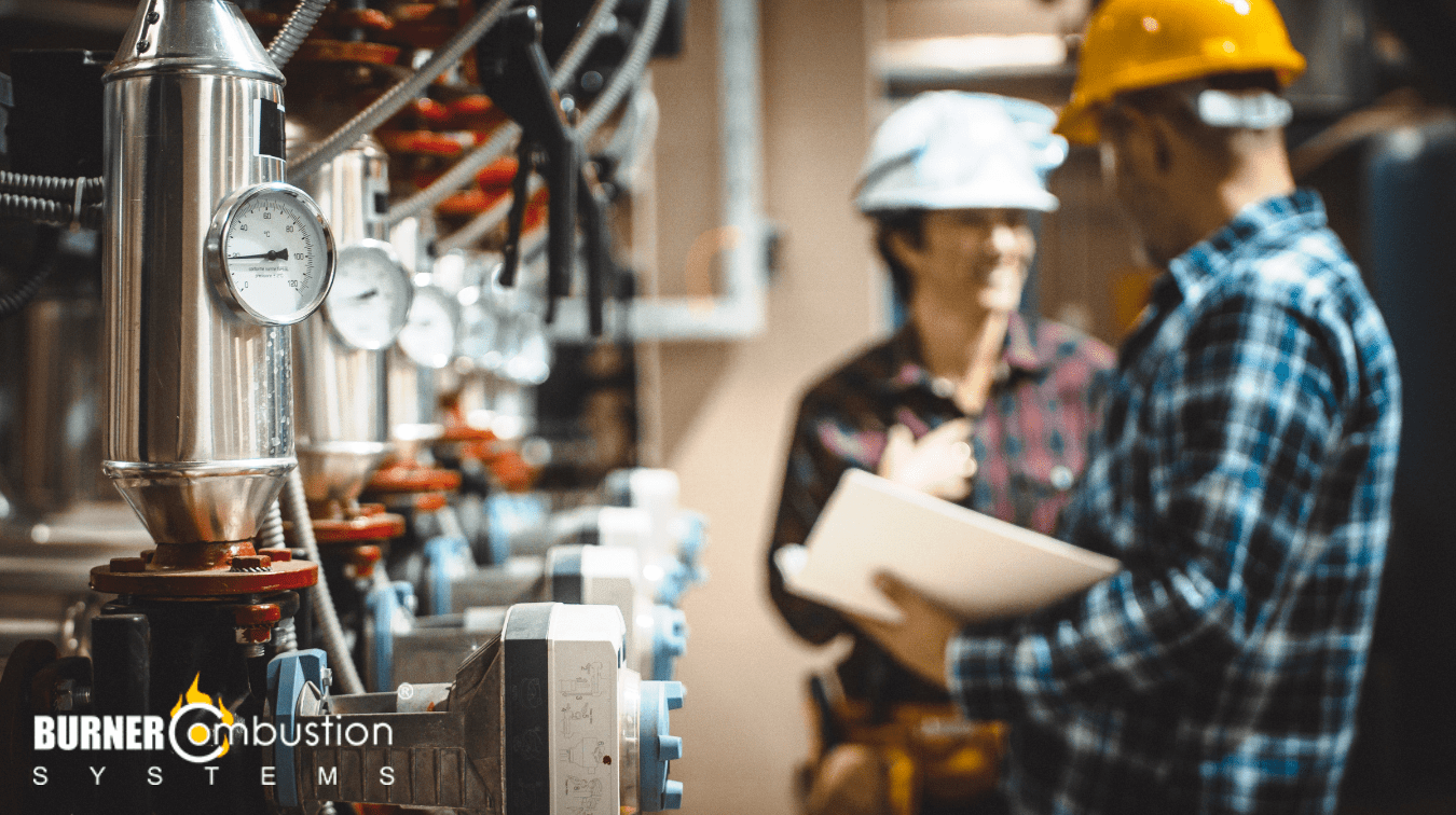 woman and man in hard hats working on a boiler system